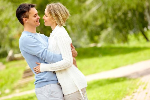 Married couple hugging in the park